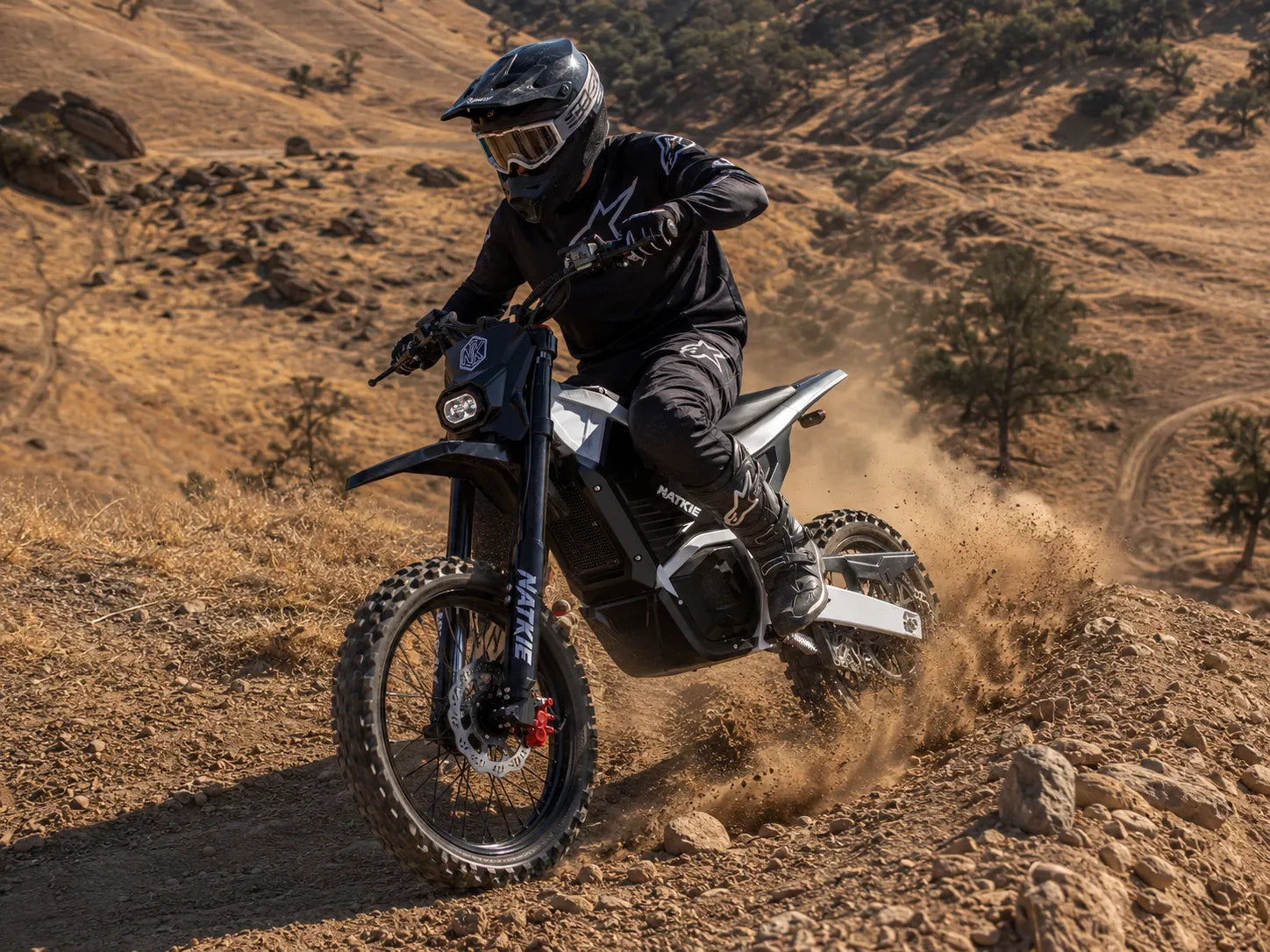 NATKIE electric dirt bike riding rugged hill terrain at Carnegie SVRA in Northern California